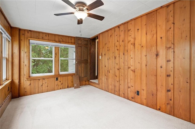 632 E 2nd St, New Richmond, WI 54017 - unfurnished room featuring carpet floors, wood walls, and a ceiling fan