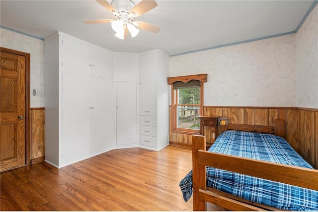 632 E 2nd St, New Richmond, WI 54017 - bedroom featuring light wood-style flooring, wainscoting, crown molding, and ceiling fan