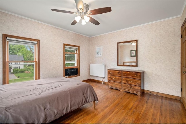 632 E 2nd St, New Richmond, WI 54017 - bedroom with wood finished floors, crown molding, and ceiling fan