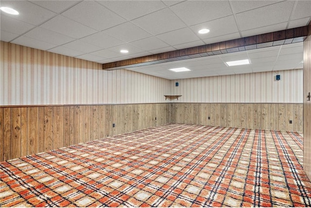 632 E 2nd St, New Richmond, WI 54017 - spare room featuring wooden walls, a wainscoted wall, a drop ceiling, and recessed lighting