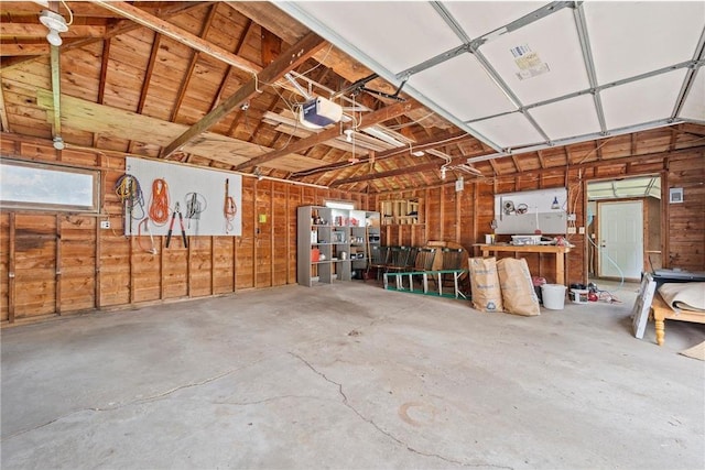 632 E 2nd St, New Richmond, WI 54017 - garage featuring a garage door opener and wood walls