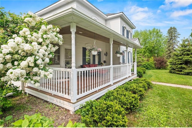 632 E 2nd St, New Richmond, WI 54017 - view of side of home with covered porch and a lawn
