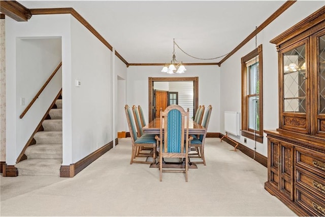 632 E 2nd St, New Richmond, WI 54017 - dining space with light colored carpet, ornamental molding, a chandelier, stairs, and radiator heating unit