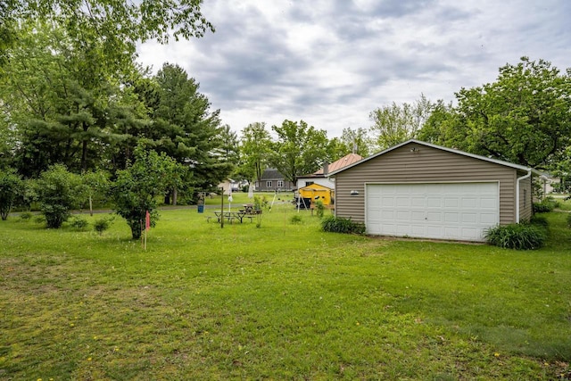 307 Jackson St, Mauston, WI 53948 - view of grassy yard featuring a garage and an outdoor structure
