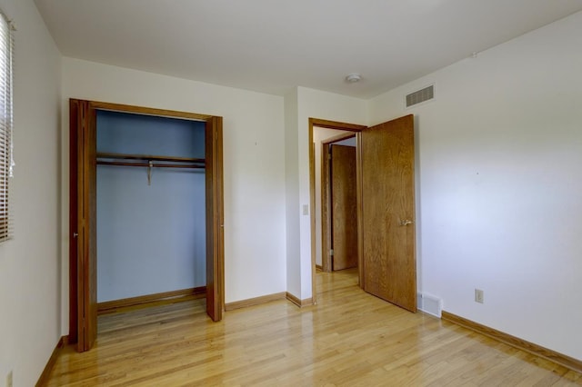 4705 Agate Ln, Madison, WI 53714 - unfurnished bedroom featuring light wood-style flooring, a closet, and baseboards