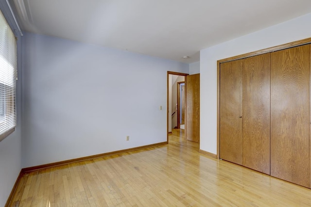 4705 Agate Ln, Madison, WI 53714 - unfurnished bedroom featuring light wood-type flooring, baseboards, and a closet
