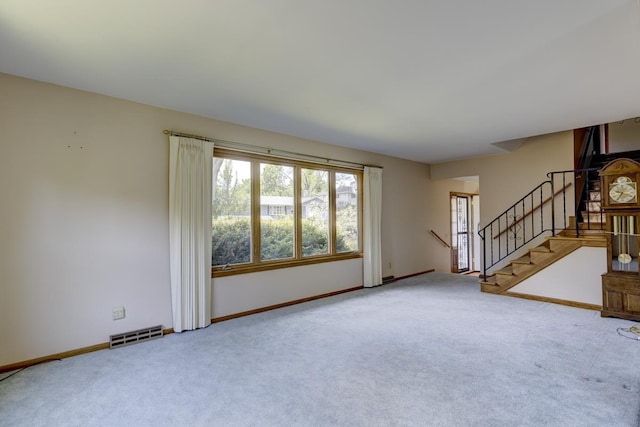 4705 Agate Ln, Madison, WI 53714 - unfurnished living room featuring carpet flooring, stairway, and baseboards
