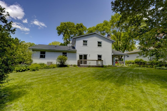 4705 Agate Ln, Madison, WI 53714 - back of property with a chimney, a lawn, and a deck