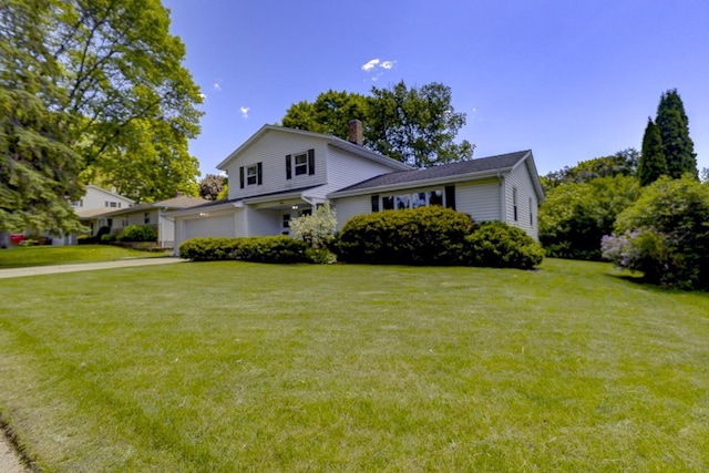4705 Agate Ln, Madison, WI 53714 - split level home with an attached garage, a front yard, a chimney, and driveway