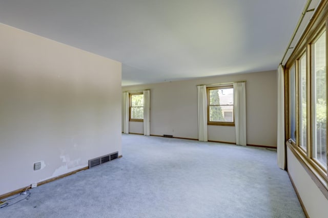 4705 Agate Ln, Madison, WI 53714 - empty room with light carpet, plenty of natural light, and baseboards
