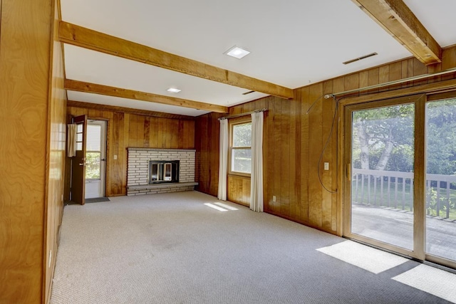 4705 Agate Ln, Madison, WI 53714 - unfurnished living room with beamed ceiling, wood walls, carpet floors, and a fireplace