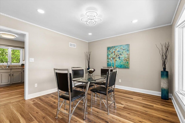 W308N5583 Windrise Cir, Hartland, WI 53029 - dining space with baseboards, ornamental molding, wood finished floors, and recessed lighting