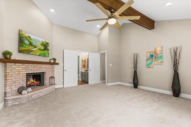 W308N5583 Windrise Cir, Hartland, WI 53029 - unfurnished living room with a ceiling fan, carpet floors, high vaulted ceiling, a fireplace, and baseboards