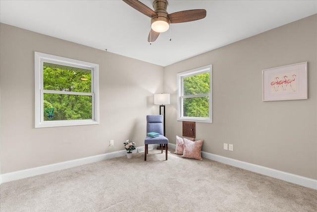W308N5583 Windrise Cir, Hartland, WI 53029 - living area featuring carpet floors, baseboards, and ceiling fan