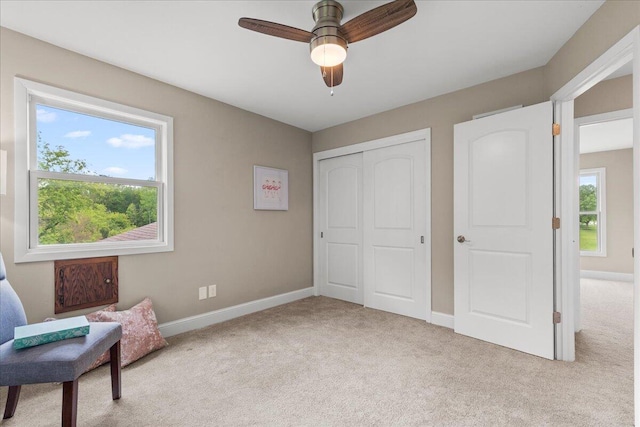W308N5583 Windrise Cir, Hartland, WI 53029 - unfurnished room with light carpet, baseboards, and a ceiling fan