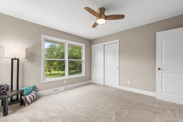 W308N5583 Windrise Cir, Hartland, WI 53029 - unfurnished bedroom with carpet, baseboards, a closet, and ceiling fan