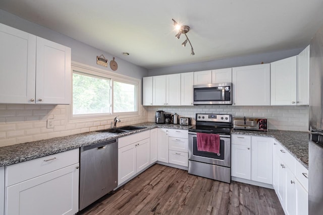 2921 Glendale Ave, La Crosse, WI 54601 - kitchen featuring appliances with stainless steel finishes, a sink, and white cabinetry