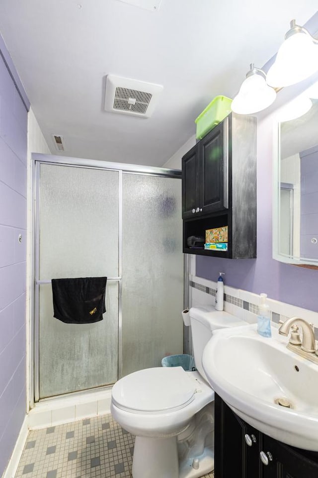 2921 Glendale Ave, La Crosse, WI 54601 - full bathroom featuring vanity, toilet, a stall shower, and tile patterned flooring