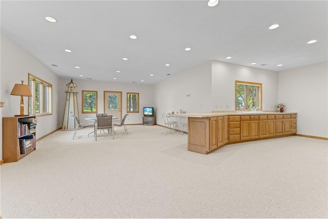 1115 S Trappers Xing, Hugo, MN 55038 - kitchen with recessed lighting, light colored carpet, baseboards, a peninsula, and light countertops