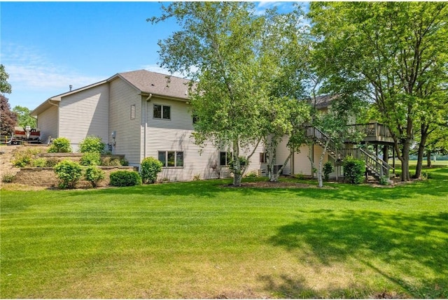 1115 S Trappers Xing, Hugo, MN 55038 - back of house with stairs, a wooden deck, and a lawn