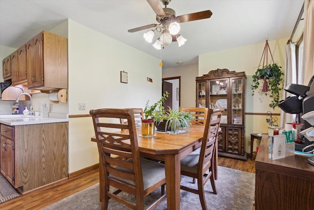551 N Crosby Ave, Janesville, WI 53548 - dining space with light wood-type flooring, ceiling fan, and baseboards