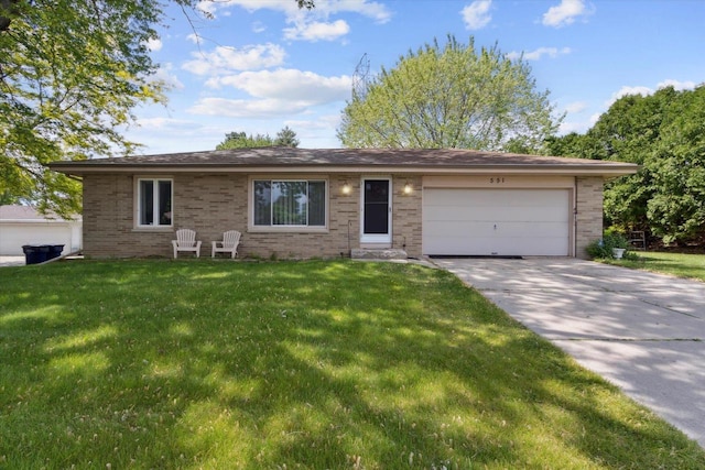 551 N Crosby Ave, Janesville, WI 53548 - ranch-style home featuring an attached garage, concrete driveway, a front yard, and brick siding