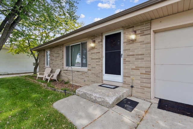 551 N Crosby Ave, Janesville, WI 53548 - property entrance featuring brick siding and a lawn