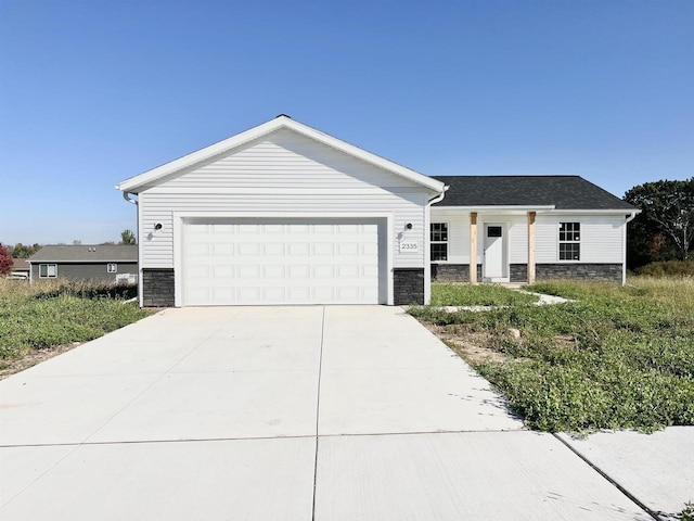 6308 Perch Dr, Weston, WI 54476 - ranch-style home with stone siding, concrete driveway, and a garage