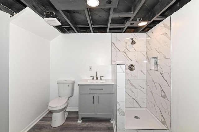 4155 N 67th St, Milwaukee, WI 53216 - full bath with toilet, a tile shower, vanity, wood finished floors, and baseboards
