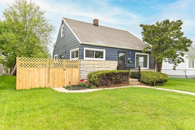 4155 N 67th St, Milwaukee, WI 53216 - view of front of house with stone siding, a shingled roof, and a chimney