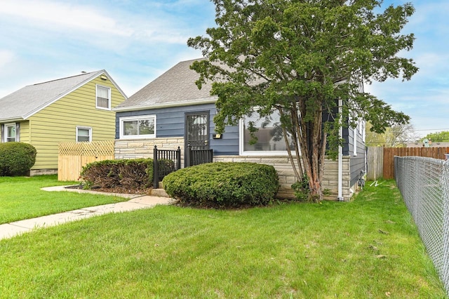 4155 N 67th St, Milwaukee, WI 53216 - view of front of property featuring a shingled roof and stone siding