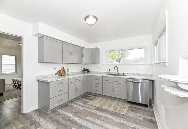 4155 N 67th St, Milwaukee, WI 53216 - kitchen featuring gray cabinetry, stainless steel dishwasher, a sink, and wood finished floors
