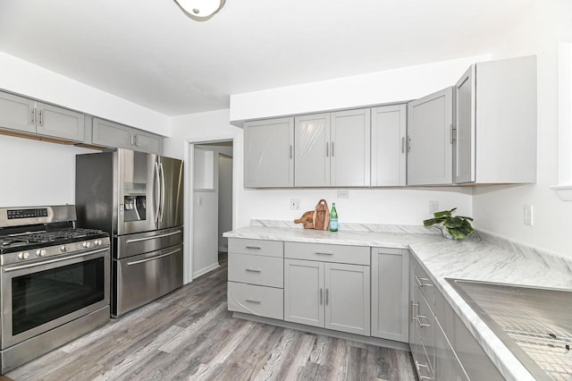 4155 N 67th St, Milwaukee, WI 53216 - kitchen with appliances with stainless steel finishes, gray cabinets, light wood-style floors, and a sink