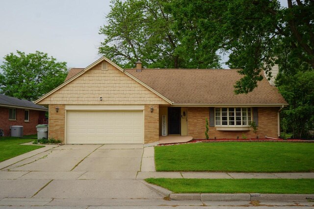 3867 S Massachusetts Ave, Milwaukee, WI 53220 - single story home featuring a garage, concrete driveway, brick siding, and a front lawn