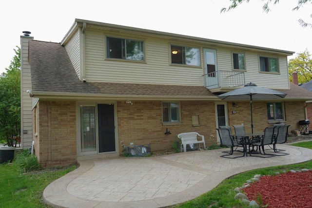 3867 S Massachusetts Ave, Milwaukee, WI 53220 - rear view of property with a patio, brick siding, a chimney, and a shingled roof
