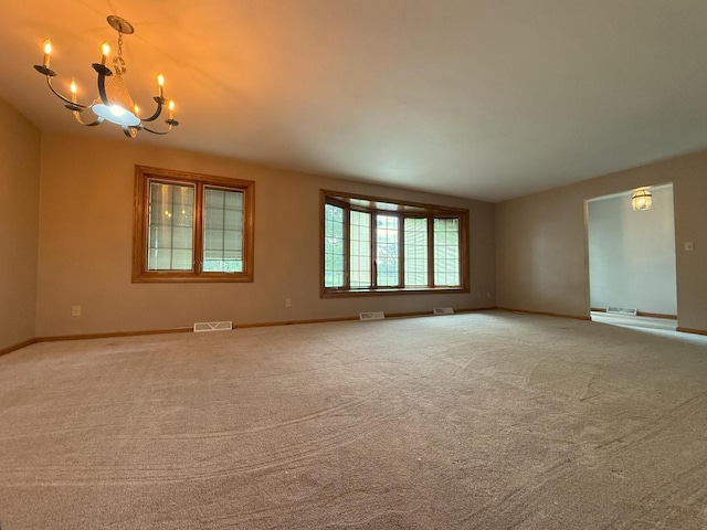 1124 Tullar Rd, Neenah, WI 54956 - carpeted empty room featuring a chandelier and baseboards