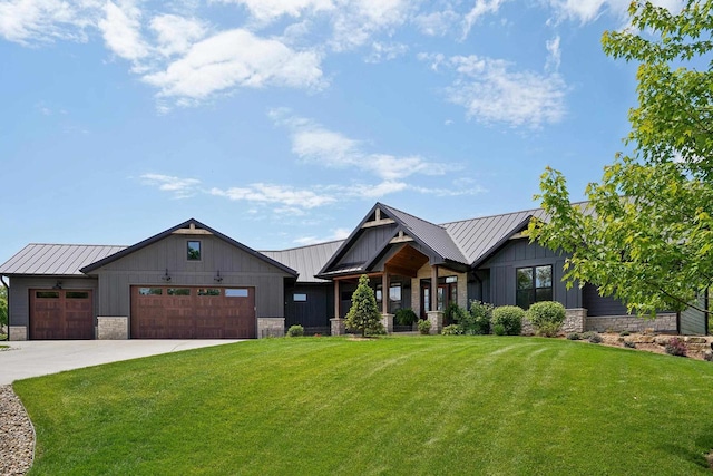 E12785 Wynding Way, Merrimac, WI 53561 - modern farmhouse with a front yard, a garage, driveway, stone siding, and a standing seam roof