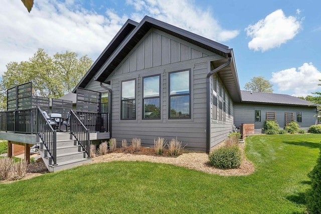 E12785 Wynding Way, Merrimac, WI 53561 - view of front of property featuring board and batten siding, a deck, and a front yard