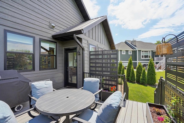E12785 Wynding Way, Merrimac, WI 53561 - wooden deck featuring outdoor dining space, a lawn, and a grill