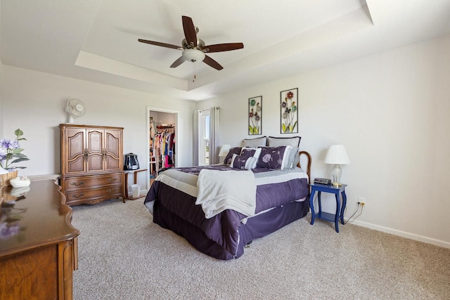 35209 Winnebago Ct, Summit, WI 53066 - bedroom featuring a raised ceiling, carpet, a walk in closet, and a closet