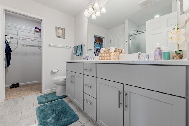 35209 Winnebago Ct, Summit, WI 53066 - full bath with vanity, a spacious closet, a stall shower, toilet, and baseboards