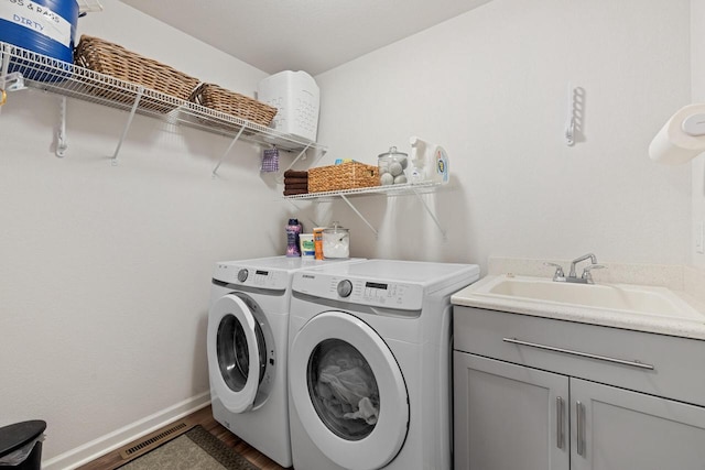 35209 Winnebago Ct, Summit, WI 53066 - laundry area with washing machine and dryer, dark wood finished floors, cabinet space, and baseboards