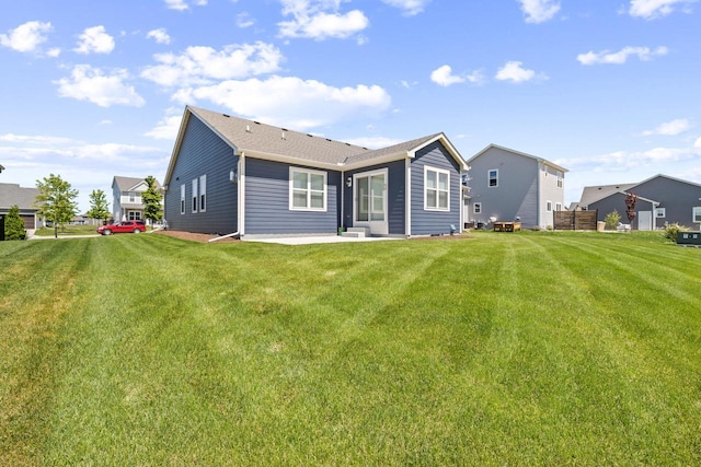 35209 Winnebago Ct, Summit, WI 53066 - rear view of house featuring a lawn and a patio