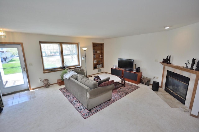 5970 S Crosswinds Dr Unit 3, Cudahy, WI 53110 - carpeted living room featuring a tile fireplace, built in shelves, and baseboards