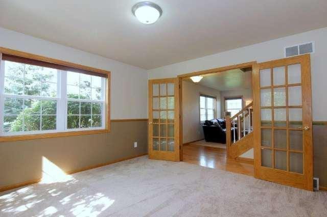 27 Waterford Cir, Madison, WI 53719 - carpeted spare room featuring french doors and stairway