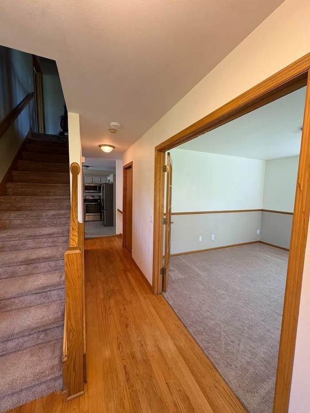 27 Waterford Cir, Madison, WI 53719 - corridor featuring stairway and wood finished floors