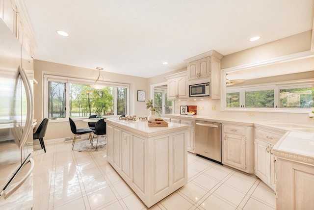 N19W22081 Fox View Ct Unit 2B, Waukesha, WI 53186 - kitchen featuring appliances with stainless steel finishes, light countertops, a kitchen island, pendant lighting, and recessed lighting