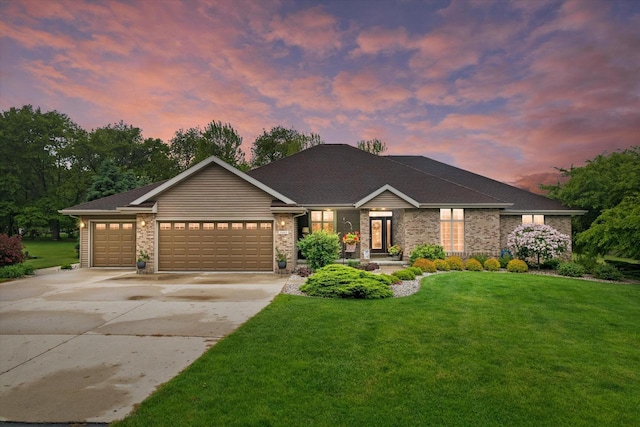 5605 N Mcnichols Dr, Milton, WI 53563 - view of front facade with a yard, an attached garage, concrete driveway, and brick siding