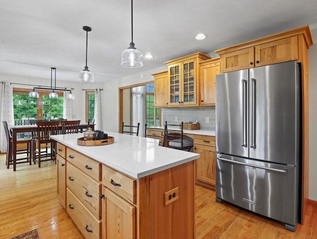 5605 N Mcnichols Dr, Milton, WI 53563 - kitchen featuring high quality fridge, light wood-style floors, recessed lighting, light countertops, and glass insert cabinets