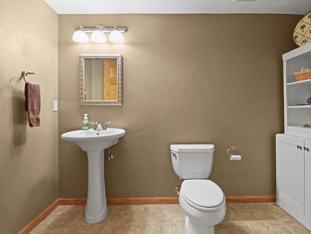 5605 N Mcnichols Dr, Milton, WI 53563 - bathroom featuring toilet, baseboards, and tile patterned floors